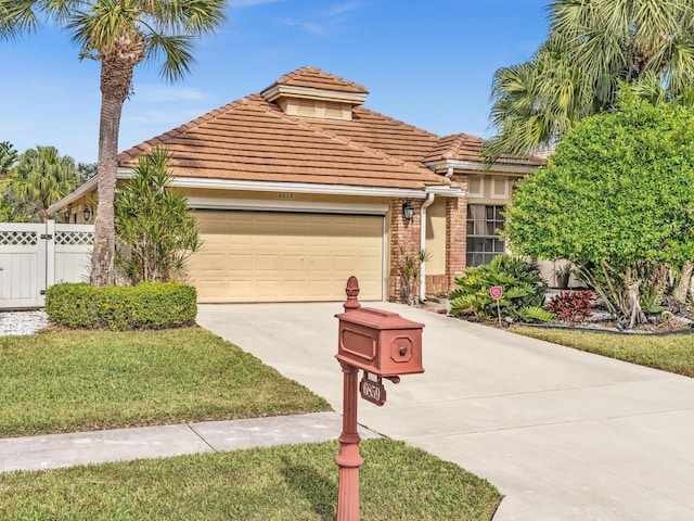 mediterranean / spanish-style house with a garage and a front lawn