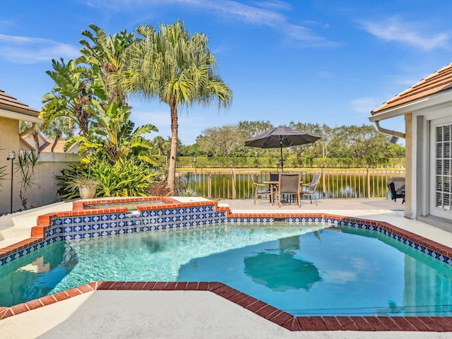 view of swimming pool with an in ground hot tub, a patio, and a water view