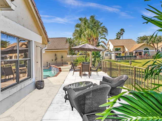 view of patio featuring an in ground hot tub