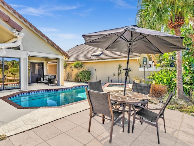 view of swimming pool with a patio area and a hot tub