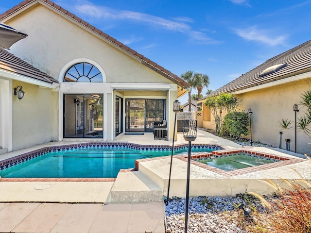 view of pool with an in ground hot tub and a patio