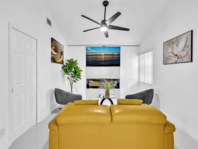 living room with ceiling fan and lofted ceiling