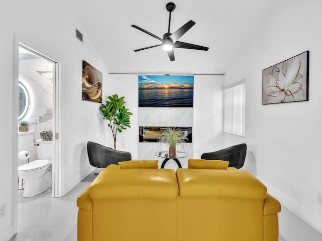 living room with ceiling fan and vaulted ceiling