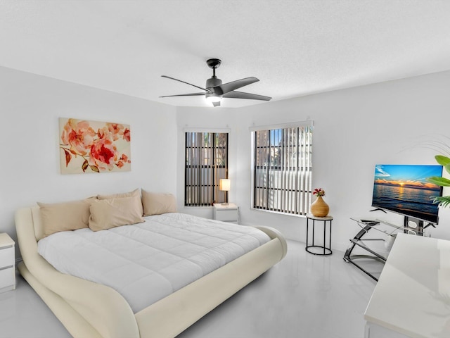 bedroom featuring ceiling fan and concrete floors