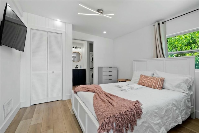 bedroom with a closet and light hardwood / wood-style floors