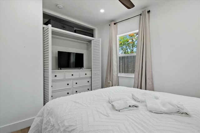 bedroom featuring ceiling fan, a closet, and hardwood / wood-style floors