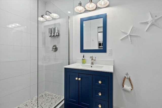 bathroom featuring a tile shower and vanity