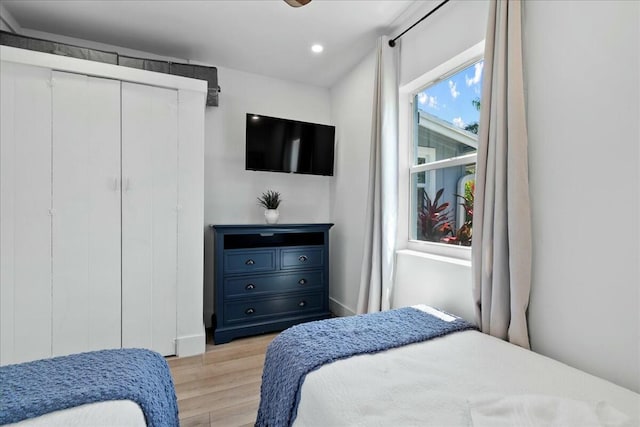 bedroom with ceiling fan and light hardwood / wood-style floors