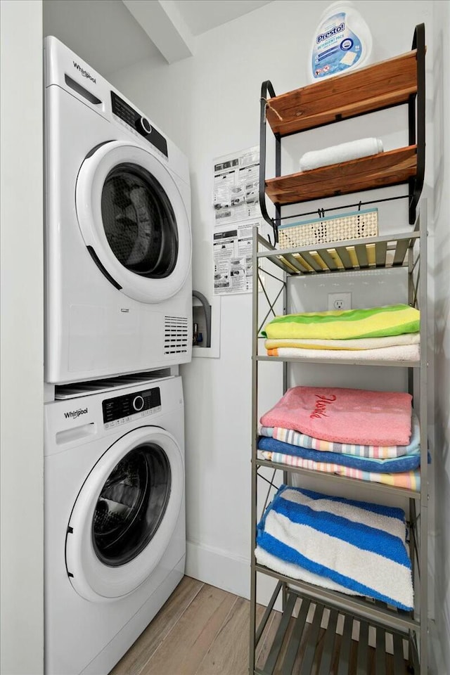 clothes washing area featuring stacked washer / drying machine