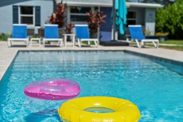 view of swimming pool featuring a patio area