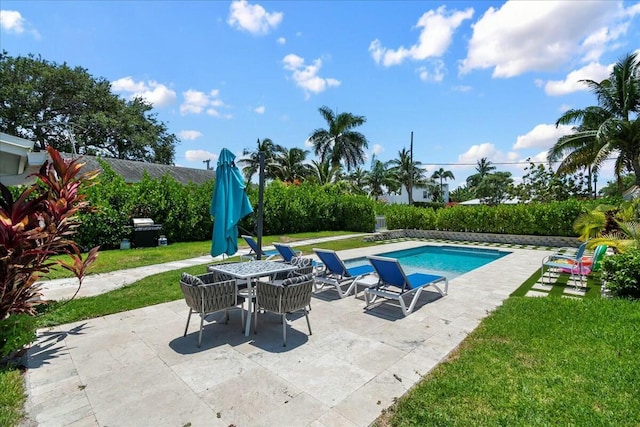 view of swimming pool featuring a yard and a patio