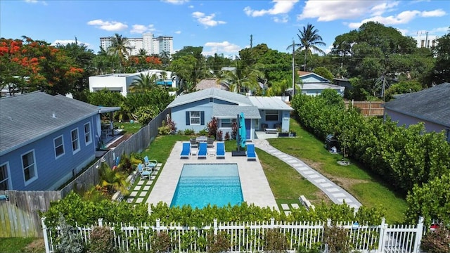 view of swimming pool featuring a patio and a lawn