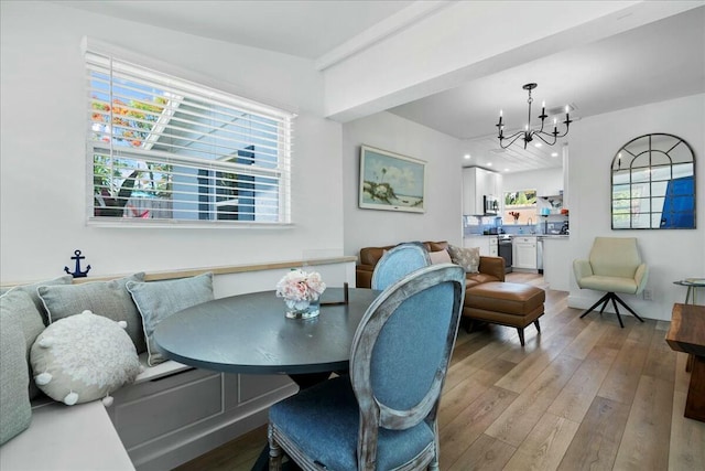 dining area featuring a chandelier, breakfast area, and light hardwood / wood-style floors