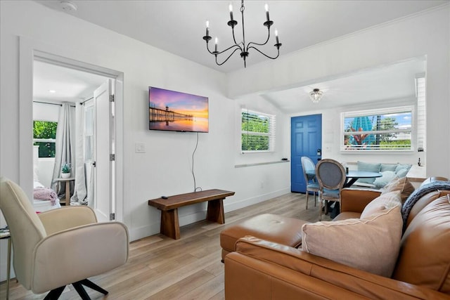 living room featuring a chandelier and light hardwood / wood-style floors