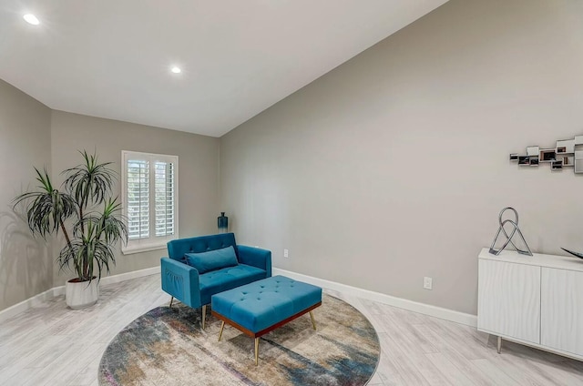 sitting room with light hardwood / wood-style floors and lofted ceiling