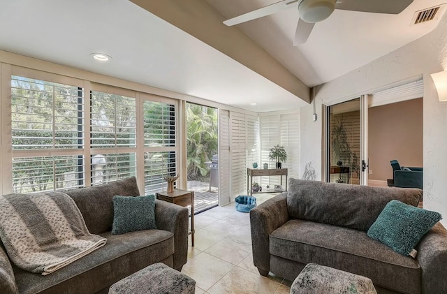 living room with ceiling fan, light tile patterned flooring, and a wealth of natural light