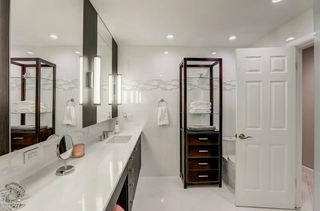 bathroom with tile patterned flooring, vanity, and toilet