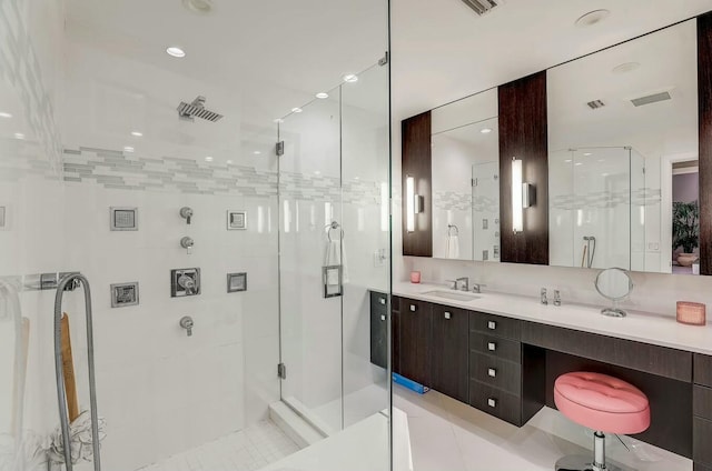 bathroom featuring tile patterned floors, a shower with door, and vanity