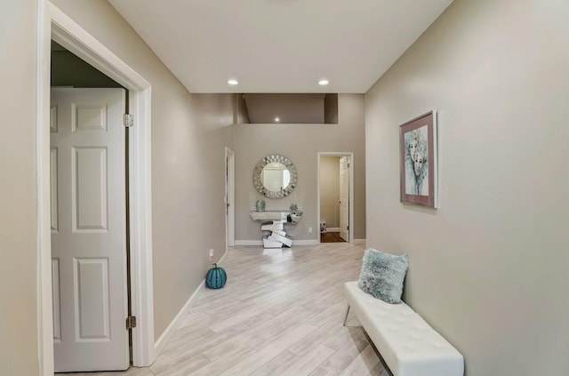 corridor with light hardwood / wood-style flooring