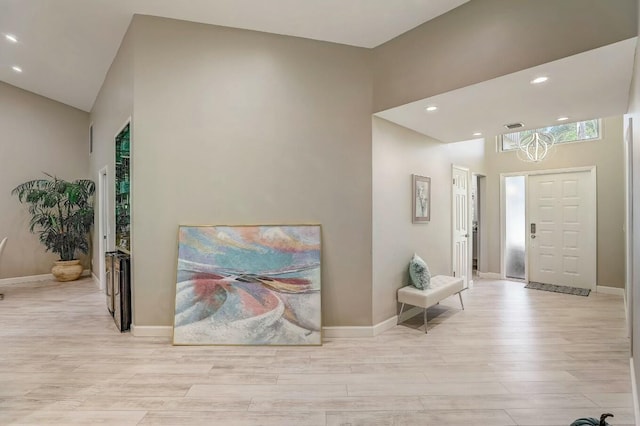 entrance foyer featuring light hardwood / wood-style floors and high vaulted ceiling