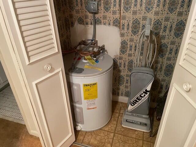 utility room featuring water heater