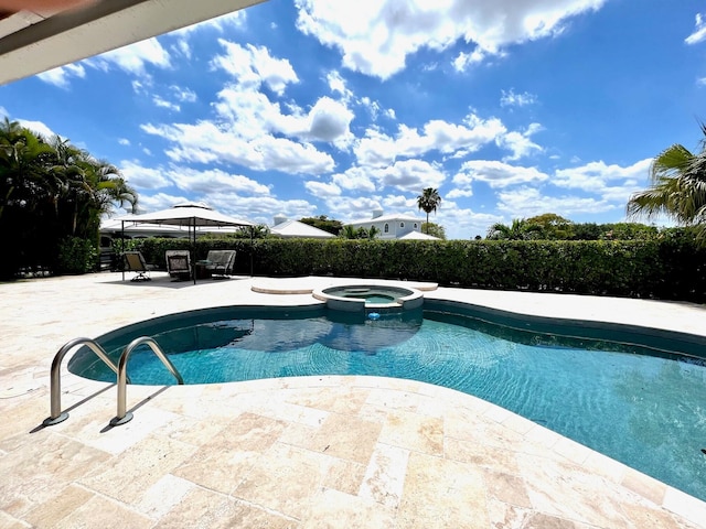 view of pool with an in ground hot tub, a gazebo, and a patio area