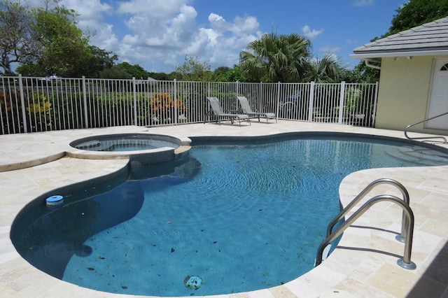 view of swimming pool with a patio area and an in ground hot tub