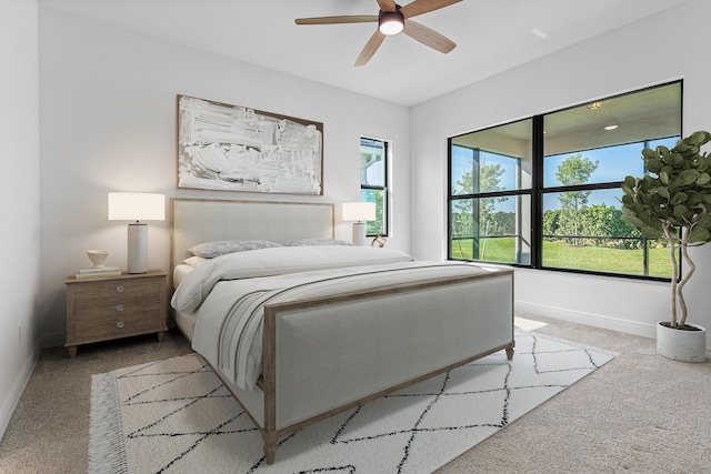 bedroom featuring ceiling fan and light carpet