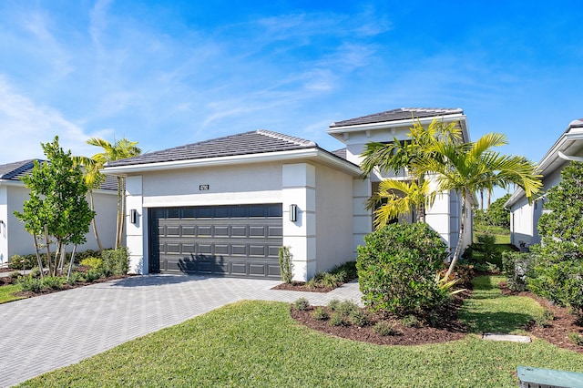 view of front of home with a front lawn and a garage