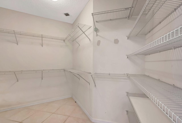 walk in closet featuring light tile patterned floors