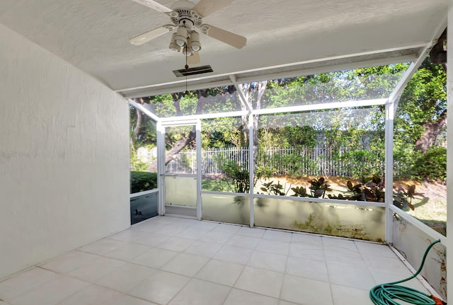 unfurnished sunroom with ceiling fan