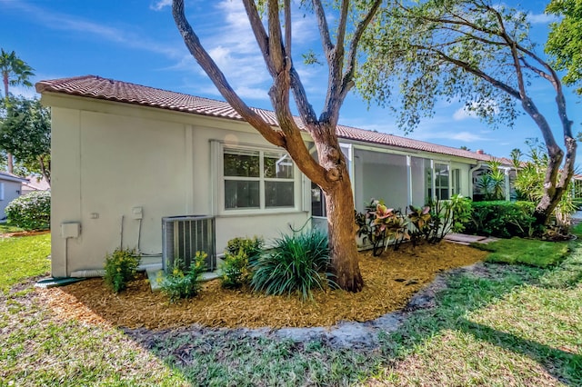 rear view of property featuring central AC