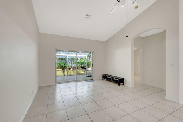 interior space with lofted ceiling and light tile patterned flooring