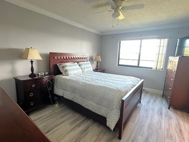 bedroom with a textured ceiling, light hardwood / wood-style floors, ceiling fan, and crown molding