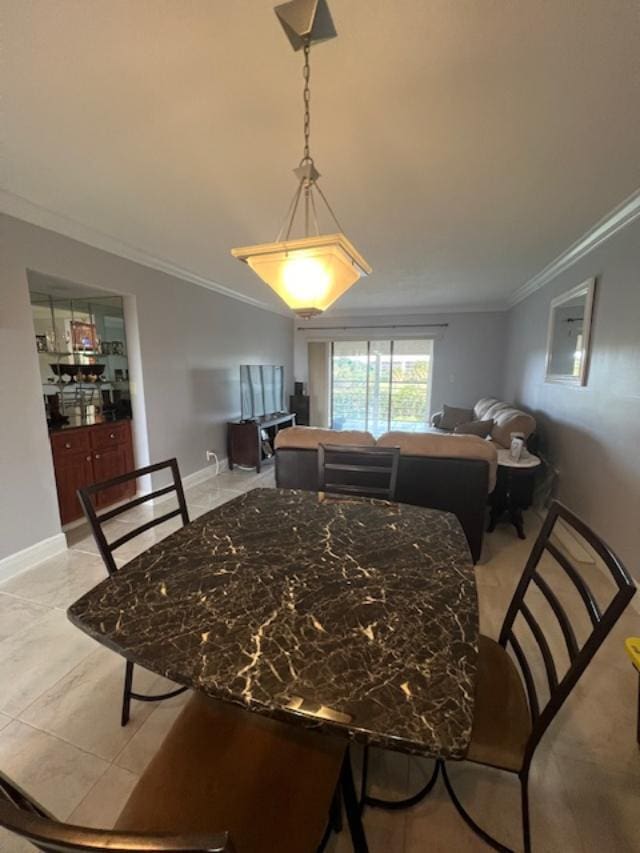 dining room with light tile patterned flooring and ornamental molding