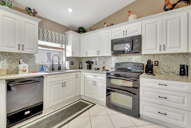 kitchen with sink, white cabinetry, lofted ceiling, and black appliances