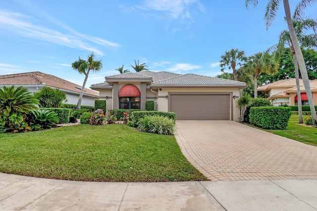 mediterranean / spanish house with a garage and a front lawn