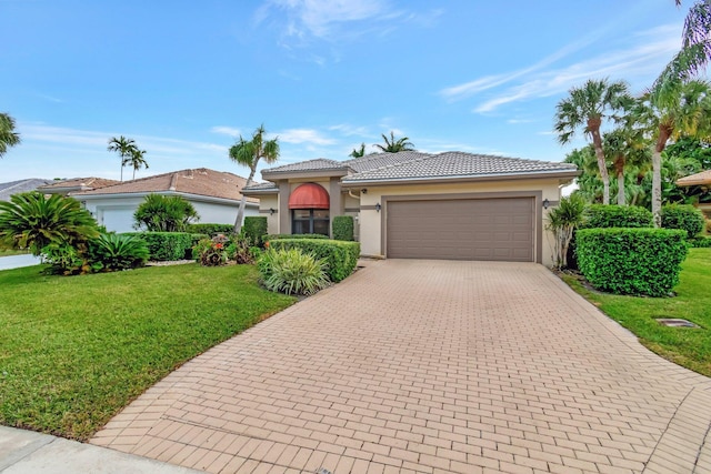 mediterranean / spanish-style house featuring a front lawn and a garage