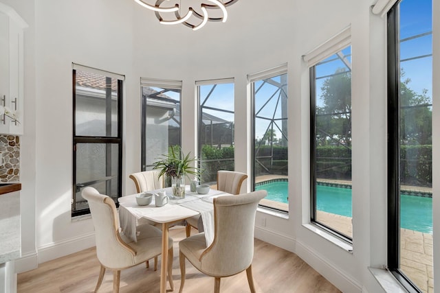 sunroom with a healthy amount of sunlight and an inviting chandelier