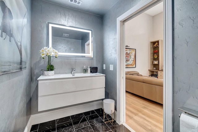 bathroom with hardwood / wood-style floors and vanity