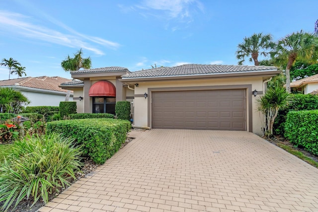 mediterranean / spanish-style house with a garage