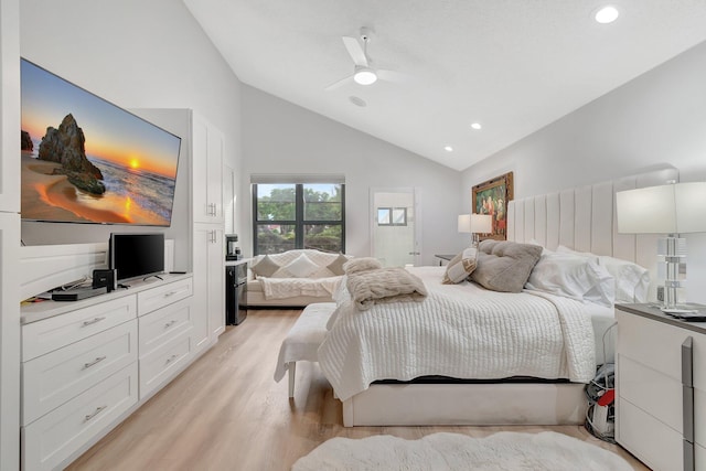 bedroom featuring ceiling fan, vaulted ceiling, and light wood-type flooring