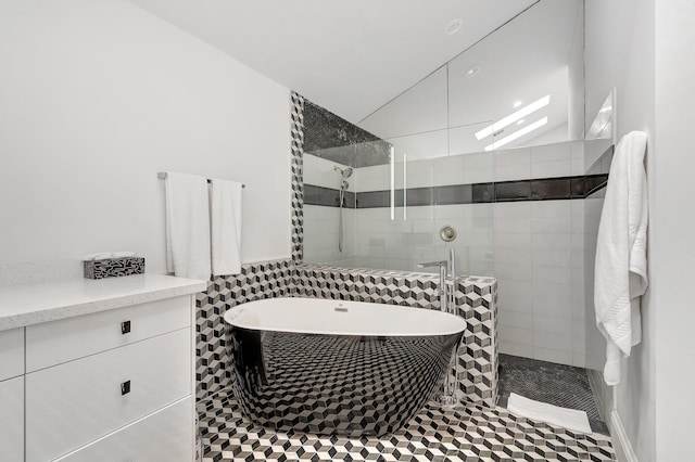 bathroom featuring tile patterned floors and separate shower and tub