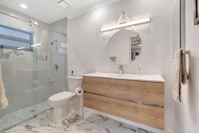 bathroom featuring vanity, toilet, a shower with shower door, and crown molding