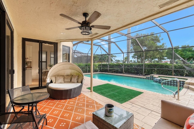 view of pool featuring a patio, ceiling fan, and a lanai