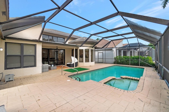 view of pool with an in ground hot tub, a patio, and a lanai