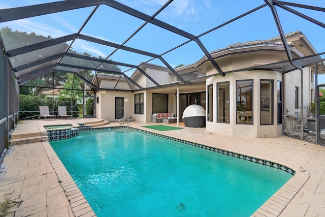 view of pool featuring an in ground hot tub, a patio, and glass enclosure