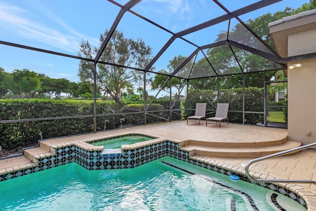 view of pool with glass enclosure, an in ground hot tub, and a patio