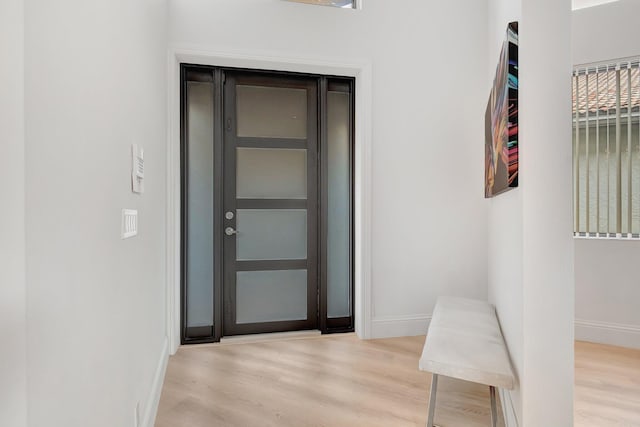 hallway with light hardwood / wood-style floors