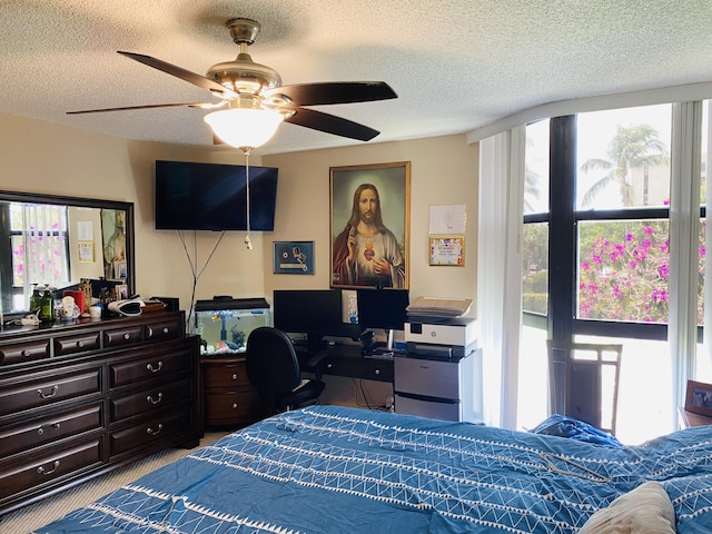 bedroom with ceiling fan and a textured ceiling